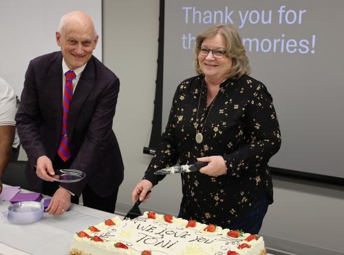 Former RMCOEH Administrative Assistant Toni Chambers, right, and Dr. Kurt Hegmann, the center's director, prepare cake during a retirement celebration for Chambers. Chambers retired at the end of December, capping a nearly two-decade career at RMCOEH in which she made significant contributions to the center's successes. 