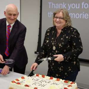 Former RMCOEH Administrative Assistant Toni Chambers, right, and Dr. Kurt Hegmann, the center's director, prepare cake during a retirement celebration for Chambers. Chambers retired at the end of December, capping a nearly two-decade career at RMCOEH in which she made significant contributions to the center's successes. 