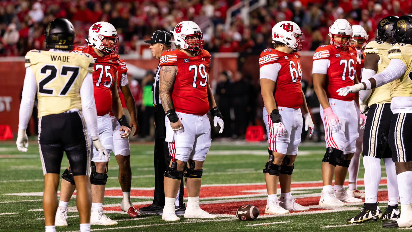 College football players from Utah and Colorado line up at midfield, with #79 Alex Harrison standing near the ball before the snap.