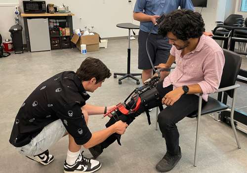 Student working with leg brace